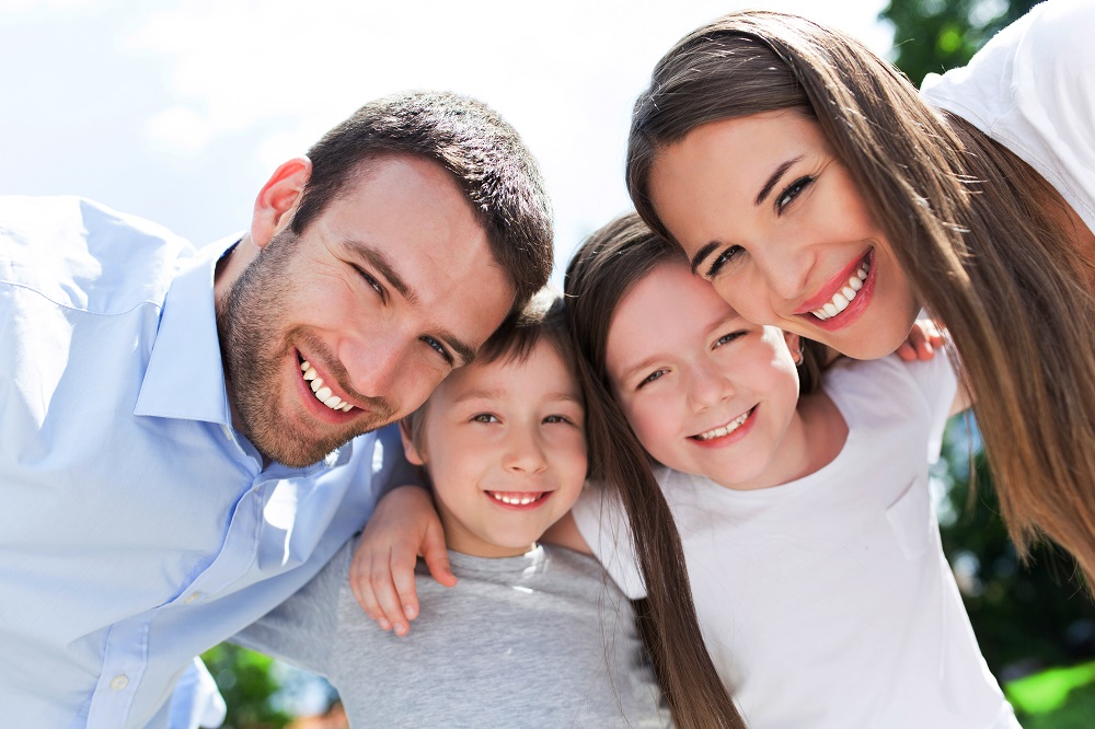 A happy family smiling outdoors